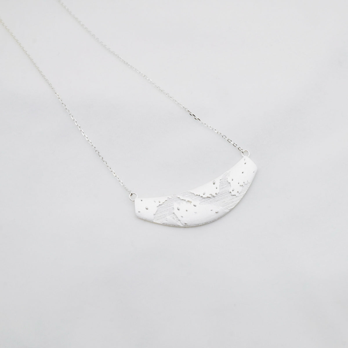 MENGJIAO FENG Brushed Texture Necklace — official product photograph on a light grey background