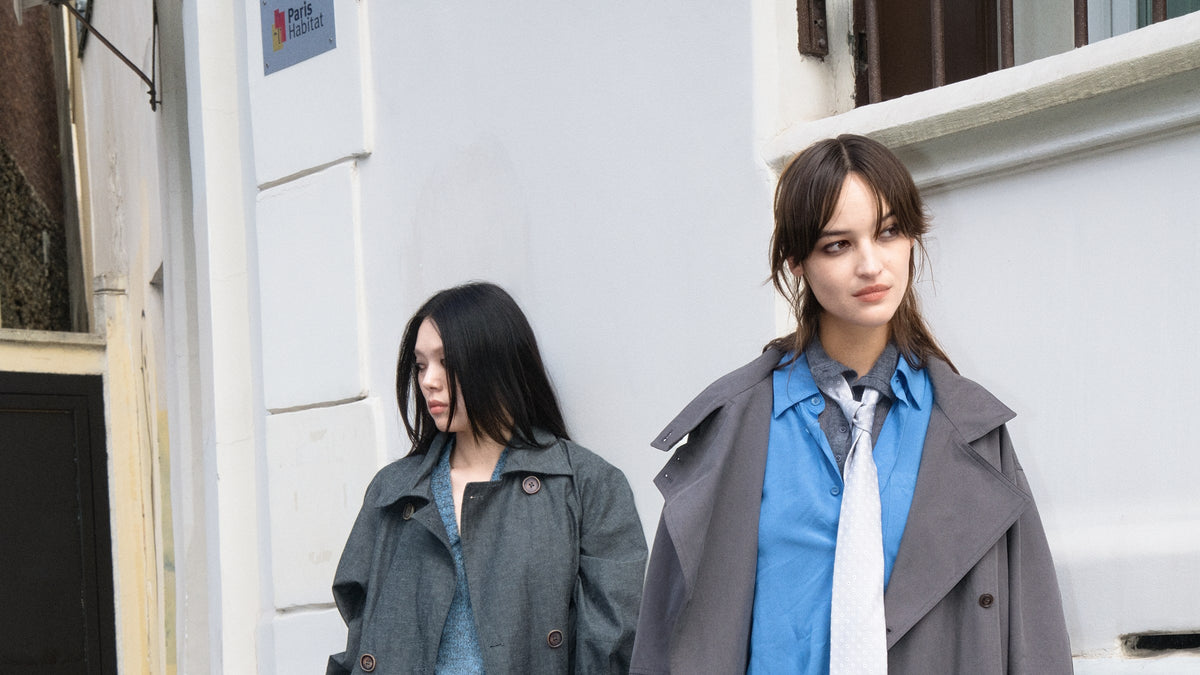 MIST Autumn Winter campaign: two models in grey outerwear with blue and cream layers in Paris.