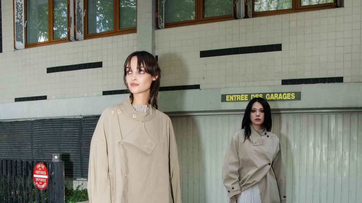 MIST Autumn Winter campaign: two models in beige outerwear styled with brown and grey pieces in Paris.