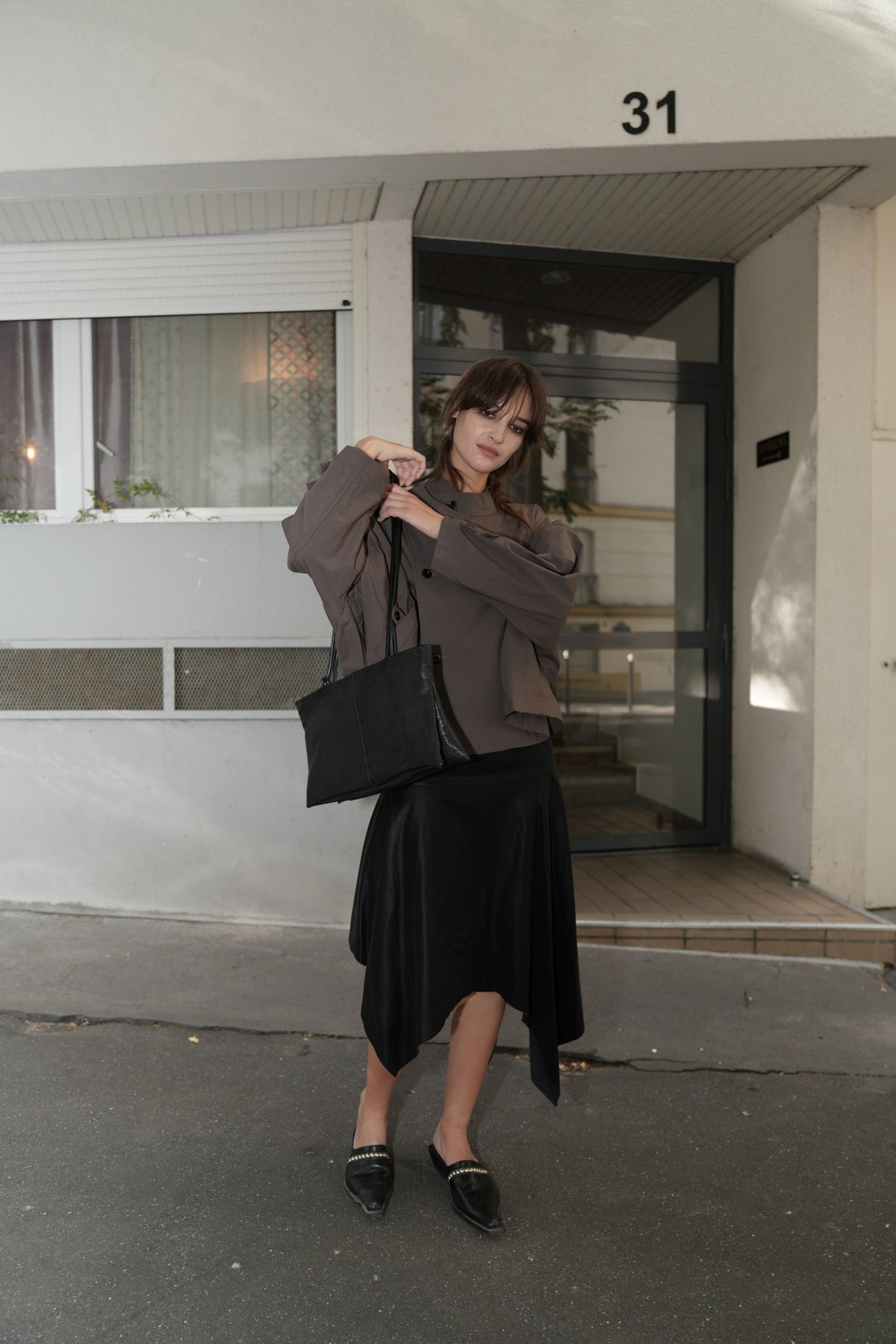 Black Long Handle Leather Bag worn by a model in Paris